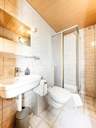 a bathroom with a sink and a toilet at Haus Schönblick in Bschlabs
