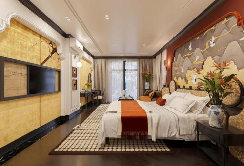 a bedroom with a large bed and a tv at The 39 Lane Hotel Hanoi in Hanoi