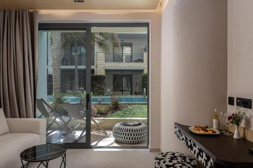 a living room with a couch and a table at Pearl Beach in Rethymno
