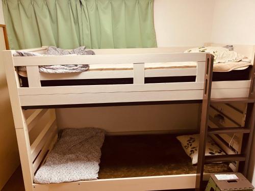 a bunk bed room with two bunk beds at Perch泉町 in Sasebo