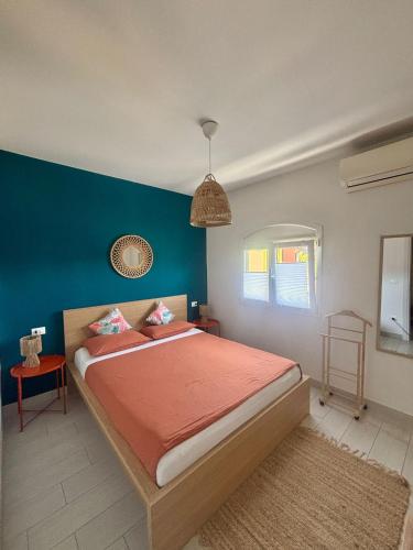 a bedroom with a bed with a blue wall at FIORDO 448 in Isola Albarella