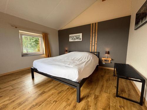 a bedroom with a bed and a window at Gite du Moulin Iris in Stavelot