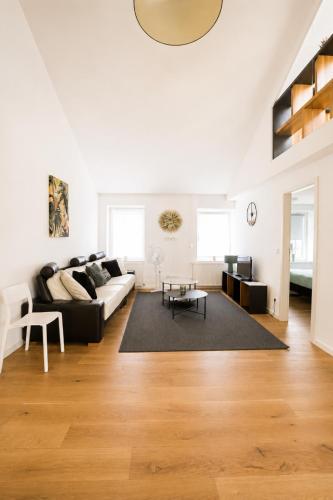a living room with a couch and a table at Core Luxembourg City in Luxembourg