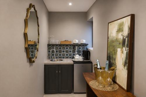a small kitchen with a counter and a sink at Belle Maroc Boutique Hotel in Bloubergstrand