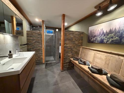 a bathroom with a bench with a sink and a shower at Berghaus Weissbriach in Weissbriach