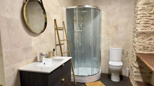 a bathroom with a shower and a sink and a toilet at Les Vieilles Planches in Pampelonne