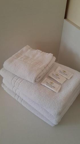 a stack of white towels sitting on top of a counter at Hotel Erechim in Porto Alegre