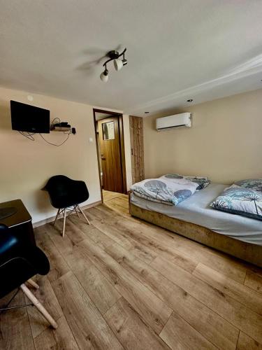 a bedroom with a bed and a desk and a chair at Noclegi nad Zaporą in Międzybrodzie Bialskie