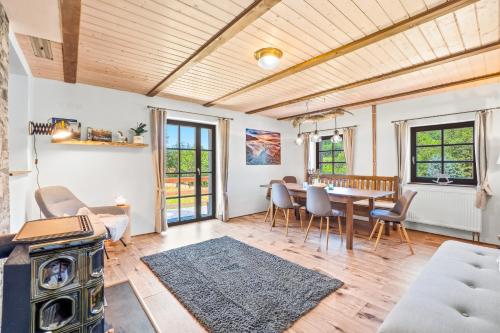 a living room with a table and chairs at NatureHouse Čeřeniště in Malečov