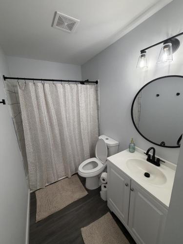 a bathroom with a toilet and a sink and a mirror at Crewe Corner D in Crewe