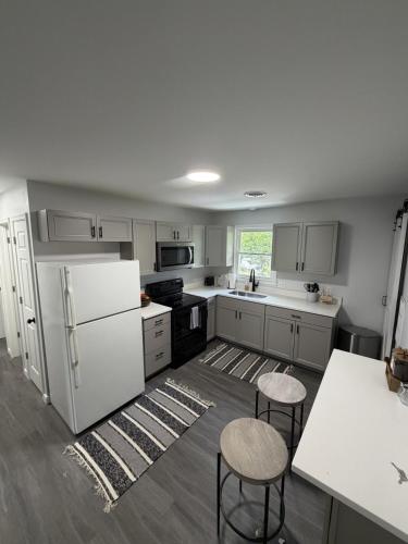 a kitchen with white appliances and tables and chairs at Crewe Corner D in Crewe