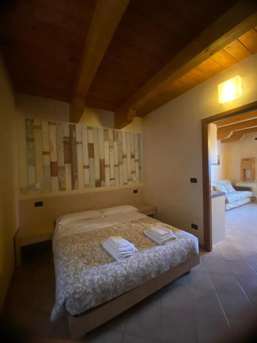 a bedroom with a bed with two towels on it at Il Poggio Agrisport in Poirino