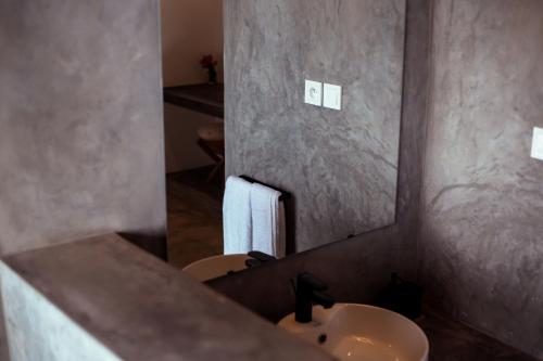 a bathroom with a sink and a mirror at Kibuye House in Kibuye
