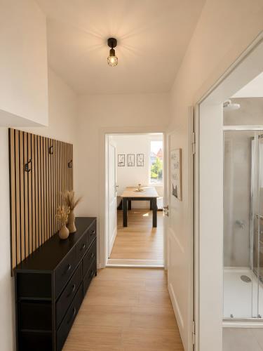 a bathroom with a black dresser and a walk in shower at Theaterblick Hildesheim in Hildesheim