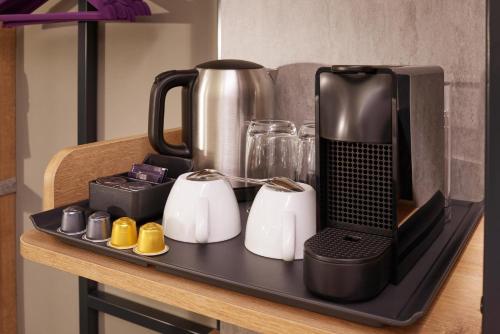 a black tray with a coffee maker on a table at Premier Inn Köln City Mediapark in Cologne