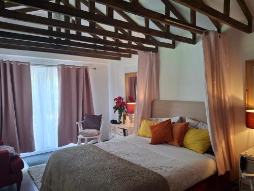 a bedroom with a large bed with a wooden ceiling at The LITTLE HOUSE in HULL in Hull