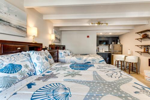 a bedroom with a bed with blue and white pillows at Dolphin & Manatee Cove Condo: Beach Access + More! in Gulf City