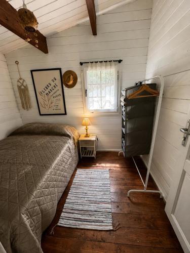 a small bedroom with a bed and a window at Desconexión y paz, cabaña en la sierra in Albalate de Zorita