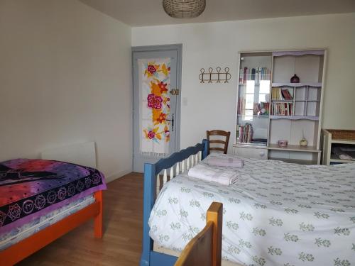 a bedroom with a blue and white bed in a room at Gite Bains jolivet in Bains