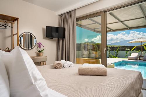 a bedroom with a bed and a pool at Alpha Waves By Banana Beach in Vasilikos