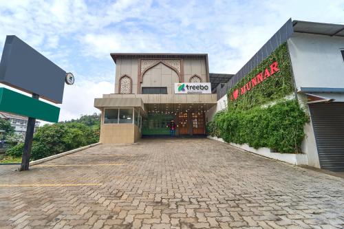 a building with a brick driveway in front of it at Treebo Belita Resort Munnar With Infinity Pool in Munnar