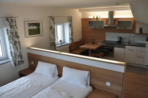 a bedroom with a bed and a kitchen with a counter at Ölerhof in Haag am Hausruck