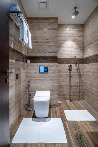 a bathroom with a toilet and a shower at ECONEST HOTEL in Tarapith