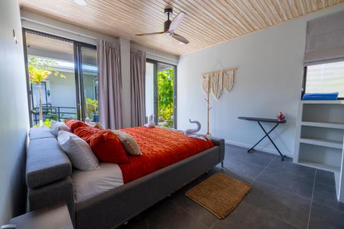 a bedroom with a bed with a red comforter at Solindo Suite in Marbella
