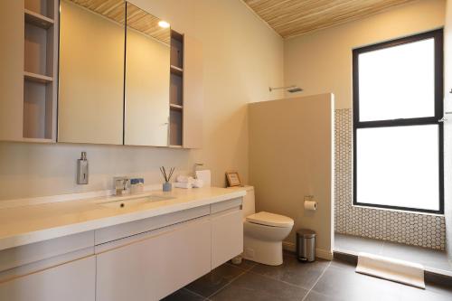 a bathroom with a sink and a toilet and a window at Solindo Suite in Marbella