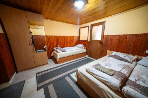 a bedroom with two beds and a shower in it at Комплекс Петлето in Sokolovtsi