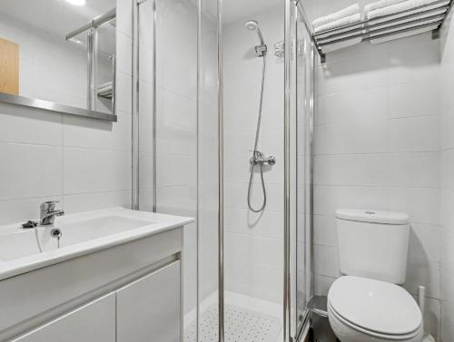 a bathroom with a shower and a toilet and a sink at Casa da Moleira in Amares