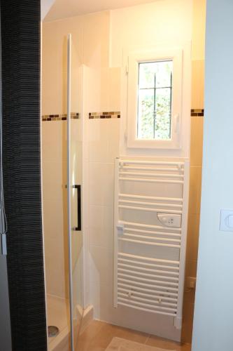 a bathroom with a shower with a window at La Bastide des Marcassins in Moissac-Bellevue