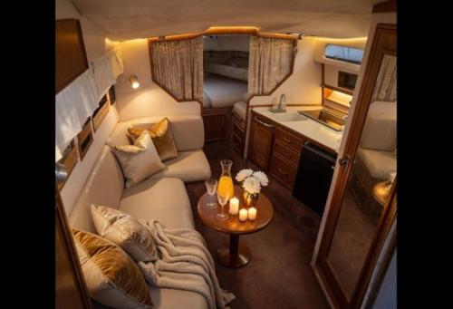 a living room in an rv with a couch and a table at Sunset boat in Leucate-Plage