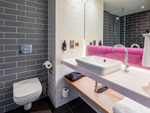 a bathroom with a sink and a toilet at Premier Inn Mannheim City Centre in Mannheim