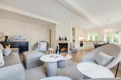 a living room with a couch and chairs and a fireplace at Seepferdchen in Keitum