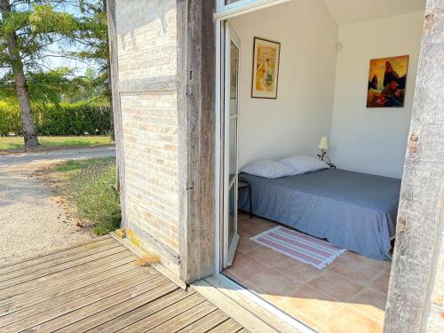 a door leading into a bedroom with a bed at Orangerie in Benais
