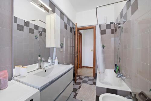 a bathroom with a sink and a toilet and a shower at Appartamento Isabella in Verbania