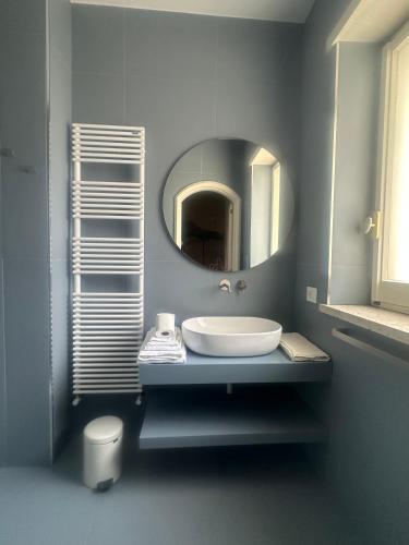 a bathroom with a sink and a mirror at Dimore Romano in Lecce