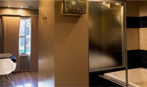a bathroom with a shower and a tub and a sink at Hotel Css in Ituzaingó