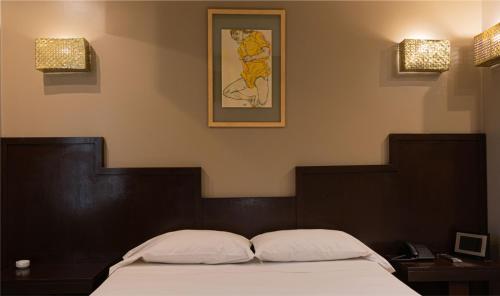 a bedroom with a bed with two pillows on it at Hotel Css in Ituzaingó