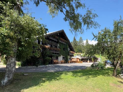 a large building with trees in front of it at Locanda dal Giulio al Fratè B&B in Madonna di Campiglio