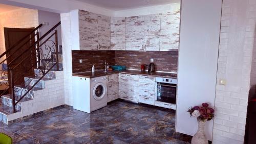 a kitchen with a sink and a washing machine at Akrotiria Beach Apart Complex in Nesebar