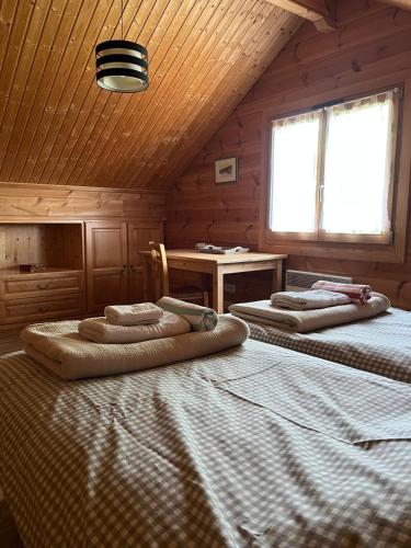 a bedroom with two beds in a wooden cabin at Chalet airelles in Saint-Pierre