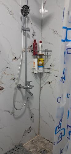 a bathroom with a shower with a shower head at AiDan BB in Kazarman