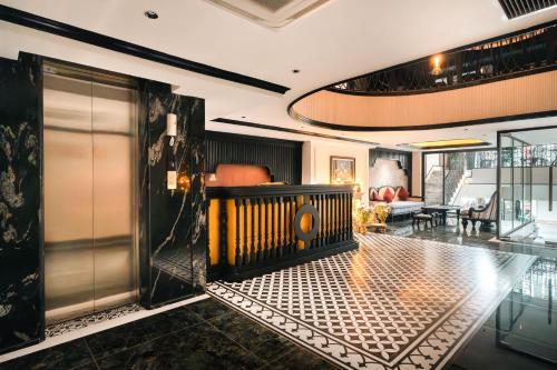 a living room with a lobby with a door and a couch at Selah Hanoi Hotel in Hanoi