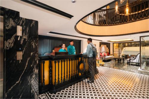 people standing at a bar in a hotel lobby at Selah Hanoi Hotel in Hanoi