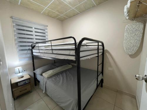 a bunk bed in a small room with a window at Casa Colibrí Volcán in Volcán