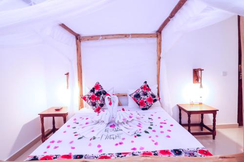 a bedroom with a bed with flowers on it at Sansi Kendwa Beach Resort in Kendwa
