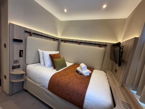 a large white bed in a small room at Mabledon Court Hotel in London