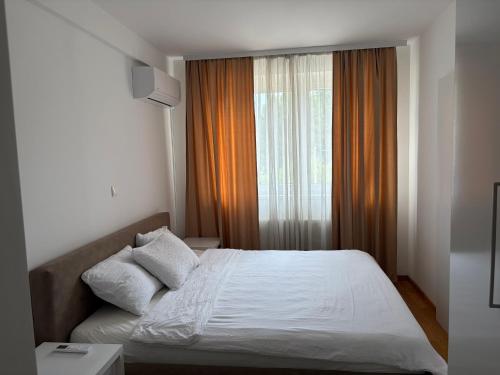 a bedroom with a bed and a large window at Panamera Luxury Apartment Ilidža in Sarajevo